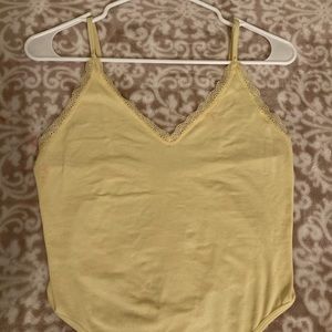 Pale yellow spaghetti strap body suite.
